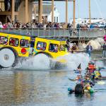 Racers make a big splash as they hit the water after rolling down the boat ramp at Northwest Maritime on Saturday. The 14 entrants in the Kinetic Skulpture race had to prove their floatability by paddling across the bay to the Port Townsend city dock, about a quarter-mile, and back to the ramp before they could participate in Sundays event. (Steve Mullensky/for Peninsula Daily News)