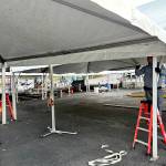 Workers set up the main tent for the Dungeness Crab Festival in downtown Port Angeles on Wednesday evening. (Kelley Lane/Peninsula Daily News)