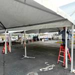 Workers set up the main tent for the Dungeness Crab Festival in downtown Port Angeles on Wednesday evening. (Kelley Lane/Peninsula Daily News)