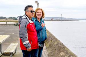 Saul and Suzanna Martinez of Monroe take in the view over the Salish Sea from Fort Worden State Park on Thursday. The couple enjoyed a quick trip to Port Townsend to celebrate their 37th wedding anniversary. (Steve Mullensky/for Peninsula Daily News)