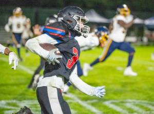 East Jefferson's Deken Lorenzen makes a 65-yard touchdown run against Annie Wright on Friday night at Port Townsend Memorial Stadium. (Steve Mullensky/for Peninsula Daily News)