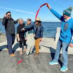 Port of Port Townsend project administrator Natalie Toews, left, Washington Recreation and Conservation Office Outdoor Grants Manager Brian Carpenter, Jefferson County Commissioner Heidi Eisenhour, Port of Port Townsend commissioners Carol Hasse and Pam Petranek and Port Executive Director Eron Berg cut the ribbon at the new Gardiner boat ramp and ADA-compliant boat launch on Discovery Bay. (Paula Hunt/Peninsula Daily News)