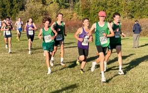 Port Angeles Cross Country 
Port Angeles top boys runners, Easton Dempsey in the pink hat and Andre Campbell, pace teammates Henry Wendel and Jay Lieberman during an Olympic League cross country race at Battle Point Park in Bainbridge.