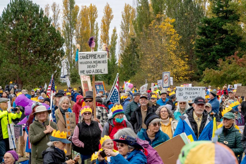 Protestors milling about at Kai Tai Lagoon on Saturday in anticipation of a march along Sims Way and Water Street to downtown Port Townsend. (Steve Mullensky/for Peninsula Daily News)