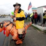 Stephen White of Port Angeles displays his inflatable T-Rex costume during Saturdays No Kings rally at the junction of First and Front streets in Port Angeles. More than 1,000 attended the rally, one of two that day in Port Angeles protesting President Donald Trump and his administration. (Keith Thorpe/Peninsula Daily News)