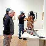 Jeanette Best Gallery visitors check out Ali Whitmores Entree  Stuffed Whole Trout during Art Walk. The sculpture won the Jurors Choice and Peoples Choice awards in the recent Potluck Banquet exhibition. (Diane Urbani/Northwind Art)