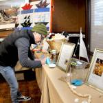 Rachel Anderson of Port Angeles fills out a raffle ticket for gifts and nautical-themed items during Wednesdays Float the Boat fundraiser benefitting the Port Angeles junior and senior high school sailing teams. The event, held at Olympic Lodge by Ayres in Port Angeles, was conducted by the nonprofit Community Boating Program to support youth sailing and other nautical programs. (Keith Thorpe/Peninsula Daily News)