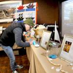 Rachel Anderson of Port Angeles fills out a raffle ticket for gifts and nautical-themed items during Wednesdays Float the Boat fundraiser benefitting the Port Angeles junior and senior high school sailing teams. The event, held at Olympic Lodge by Ayres in Port Angeles, was conducted by the nonprofit Community Boating Program to support youth sailing and other nautical programs. (Keith Thorpe/Peninsula Daily News)