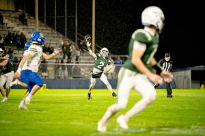 Port Angeles Carson Waddell (2) throws the ball against Bremerton on Friday night. Torrential rain at the beginning of the game affected play, especially in the first half. (Diamond Gentile/for Peninsula Daily News)