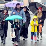 Trick or treaters and parents, from left, Angelina Simpson, Charlie Simpson, 6, Matt Simpson, Carmen Moody, Maximillion Dempsey, 7, and Holly Dempsey, all of Port Angeles, make their way through downtown Port Angeles under a moderate rain shower on Halloween Day. Many downtown merchants opened their doors with candy and treats to welcome soggy spooks, wet witches and other assorted cartoon characters in search of sweet snacks. (Keith Thorpe/Peninsula Daily News)
