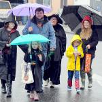 Trick or treaters and parents, from left, Angelina Simpson, Charlie Simpson, 6, Matt Simpson, Carmen Moody, Maximillion Dempsey, 7, and Holly Dempsey, all of Port Angeles, make their way through downtown Port Angeles under a moderate rain shower on Halloween Day. Many downtown merchants opened their doors with candy and treats to welcome soggy spooks, wet witches and other assorted cartoon characters in search of sweet snacks. (Keith Thorpe/Peninsula Daily News)