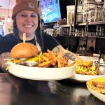 Jaclyn Wagner, co-owner of Sunshine Cafe and Bar, carries out an order to customers. She and her partner Alex Kirchner bought the restaurant just over a year ago and encourage locals to make it a weekly stop, whether for lunch or just coffee. (Matthew Nash/Olympic Peninsula News Group)
