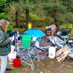 Janna Hall, 71, who said she lived at a homeless camp in Port Townsend for seven weeks, looks over her possessions that were to be moved by 5 p.m. Monday. Hall said she will be moving to an apartment in Portland today and she hopes to work part-time as a caregiver. (Steve Mullensky/for Peninsula Daily News)