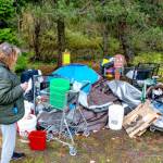 Janna Hall, 71, who said she lived at a homeless camp in Port Townsend for seven weeks, looks over her possessions that were to be moved by 5 p.m. Monday. Hall said she will be moving to an apartment in Portland today and she hopes to work part-time as a caregiver. (Steve Mullensky/for Peninsula Daily News)