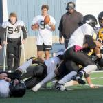 Lonnie Archibald/for Peninsula Daily News Forks Estevan Ramos (yellow helmet) is tackled during a 2024 game against Meridian. Ramos made the All Central 2B League, Western Division second team as both a kick return specialist and as a wide receiver.