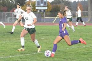 Port Angeles' Emma Desjardins, left, made the first team All-Olympic League as a freshman after scoring 21 goals for the Roughriders. Here she is defending Sequim's Ruby Moxley-Horgan, who made the league's second team. (Matthew Nash/Olympic Peninsula News Group)