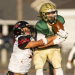 DeSales Maddox Filan catches a pass from quarterback Cohen Wood before Neah Bays Caleb Cummins tackles him during their 2025 their class 1B championship football quarterfinal at Walla Walla High School on Saturday. Neah Bay stayed close to DeSales until the fourth quarter when the Fighting Irish scored 22 straight points to win 58-24. Neah Bay, which traveled 1,830 miles to play its two state playoff games in Colfax and Walla Walla, finished its season with an 8-3 record. (Kezia Setyawan/Walla Walla Union-Bulletin)