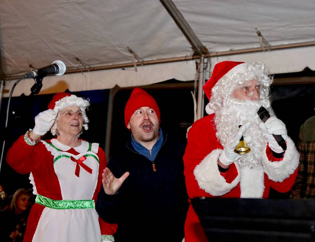 Santa and Mrs. Claus (Bob and Kathy Nicholls) and Sam Grello, executive director of the Port Angeles Waterfront District, countdown to the lighting of the 34-foot tree Saturday evening. (Dave Logan/For Peninsula Daily News)