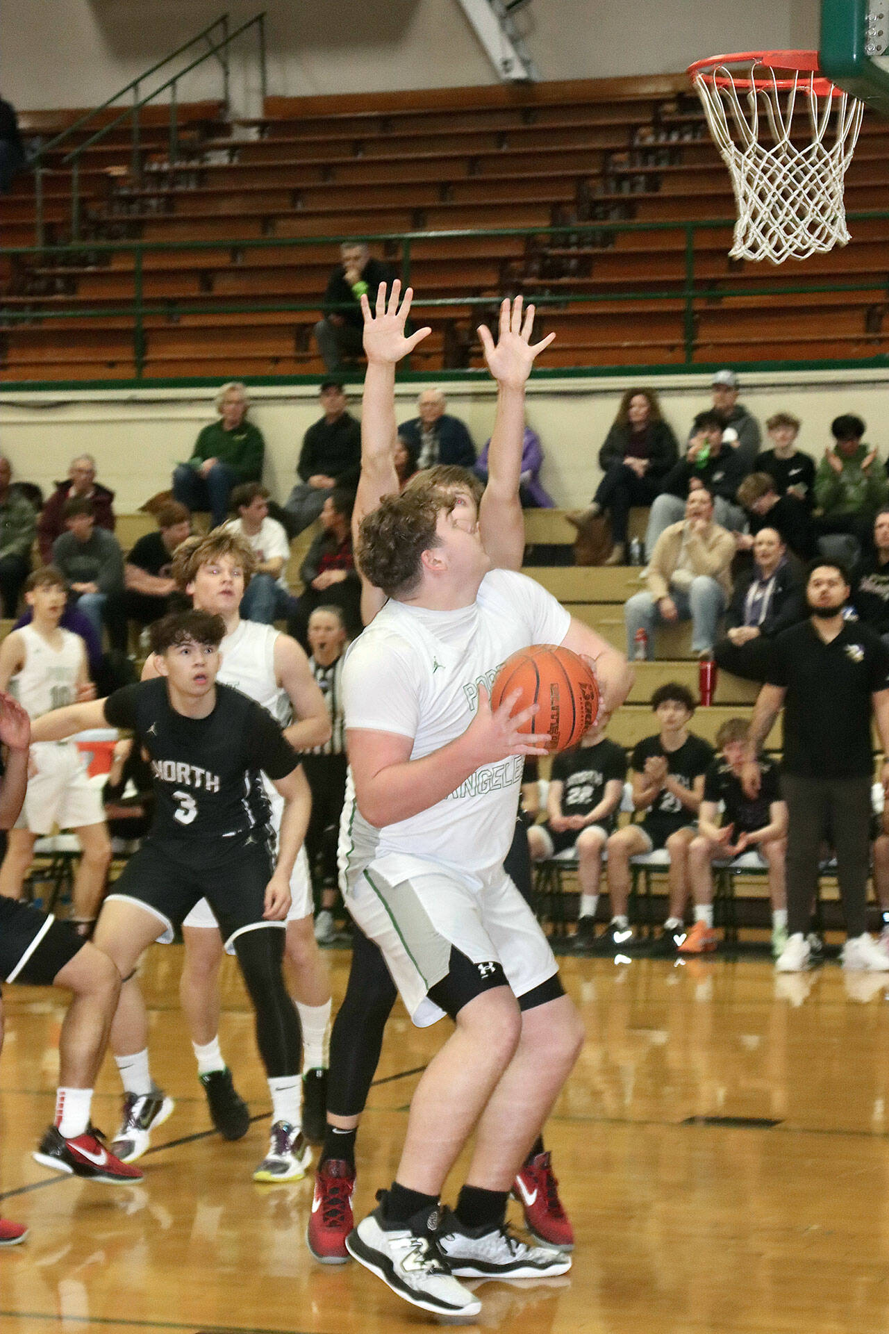 Port Angeles 6-foot-10 post Brock Hope eyes the basket last year against North Kitsap. Hope is part of a tall front line for the Roughriders this season. (Dave Logan/for Peninsula Daily News)