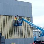 Crews work to remove metal siding on the north side of Field Arts & Events Hall on Thursday in Port Angeles. The siding is being removed so it can be replaced. (Dave Logan/for Peninsula Daily News)