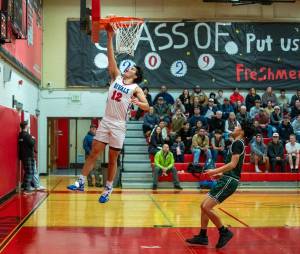 Steve Mullensky/for Peninsula Daily News 
East Jeffersons Luke OHara rises for a layup during the Rivals 71-42 season-opening win over Nisqually League foe Charles Wright on Thursday at Bruce Blevins Gymnasium.