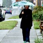 Sue Bahl walks with an umbrella on West Eighth Street on Monday. Heavy rainfall up to 8 inches over the past several days has increased the threat of landslides in Western Washington, according to the National Weather Service. A flood watch also has been issued until 4 p.m. Friday for portions of northwest and west central Washington, including Clallam and Jefferson counties. Sharp rises in rivers, especially those flowing off the Olympics and Cascades, are expected, the National Weather Service said. (Dave Logan/for Peninsula Daily News)