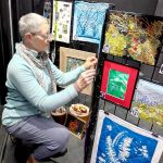 Debra E. Olson, a Port Townsend fiber artist, puts the finishing touches on the Small But Mighty exhibit at 675 Tyler St. in uptown Port Townsend.