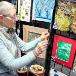 Debra E. Olson, a Port Townsend fiber artist, puts the finishing touches on the Small But Mighty exhibit at 675 Tyler St. in uptown Port Townsend.