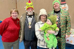 Pictured, from left, are Rae Leiper, president of the Joyce Fire Auxiliary; Keith Sowders, runner-up Grinch; Larrissa Garrison with Jayce, the 2025 Joyce Grinch; and second runner-up Grinch Brian Rice.