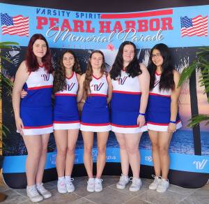 North Olympic Peninsula cheerleaders performed in the Pearl Harbor Memorial Parade on Dec. 7 in front of thousands of spectators lining the streets at Hawaiis Waikiki Beach. From left, Port Angeles Madison Bishop, Forks Danikka King and Libby Owen and Port Angeles Addisen McNeece and Melia Webber.