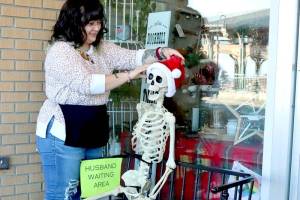 Tippy Munger, an employee at Olympic Stationers on East Front Street in Port Angeles, puts out a welcoming display for holiday shoppers just outside the business door every day. She said several men have sat there waiting while their wives shop inside. (Dave Logan/for Peninsula Daily News)