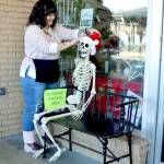Tippy Munger, an employee at Olympic Stationers on East Front Street in Port Angeles, puts out a welcoming display for holiday shoppers just outside the business door every day. She said several men have sat there waiting while their wives shop inside. (Dave Logan/for Peninsula Daily News)