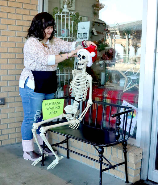 Tippy Munger, an employee at Olympic Stationers on East Front Street in Port Angeles, puts out a welcoming display for holiday shoppers just outside the business door every day. She said several men have sat there waiting while their wives shop inside. (Dave Logan/for Peninsula Daily News)