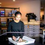 Art Director Aviela Maynard quality checks a mushroom glow puzzle. (Beckett Pintair)