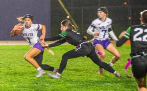 Emily Matthiessen/for Peninsula Daily News 
Sequims Raimey Brewer avoids a flag grab by a Klahowya player during an Olympic League flag football game, the first on the Sequim High School football field.