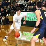 Port Angeles' Brody Pierce drives the lane against Bainbridge on Friday in Port Angeles. The short-handed Roughriders kept pace with the Spartans until the final three minutes of the first half. (Dave Logan/for Peninsula Daily News)