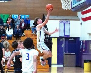 Sequim's Mason Rapelje goes in for a layup during Friday's victory over North Mason. The Wolves came back from a double-digit deficit to win 64-56. (Emily Matthiessen/for Peninsula Daily News)