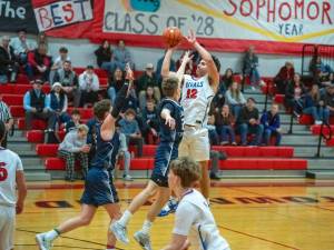 Steve Mullensky/for Peninsula Daily News
East Jeffersons Luke OHara drains a 3-pointer from the top of the key over the outstretched arm of a Cascade Christian opponent during a Nisqually League game at Bruce Blevins Gymnasium.