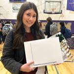 Kendra Dodson holds a new MacBook she received through the Winter Wishes assembly at Sequim High School. Im just blown away by my teachers, she said. Our staff is very amazing. I feel very lucky. (Matthew Nash/Olympic Peninsula News Group)