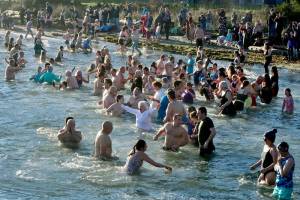 About 150 to 200 people jumped into 49-degree water at Hollywood Beach on Jan. 1, 2025, for the 37th annual Polar Bear Dip. The air temperature was about 39 degrees, so it was a short, brisk dip that they did three times. There was a beach fire to warm the dippers afterward as well as two portable saunas in the parking lot. The event was sponsored by Volunteer Hospice of Clallam County under the leadership of organizer Dan Welden. Hot drinks, tasty muffins and a certificate for participants were available. (Dave Logan/for Olympic Peninsula News Group)