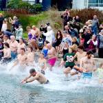 About 100 people dipped three times into the water during the 38th annual Polar Bear Dip on Thursday at Hollywood Beach in downtown Port Angeles. The air and water temperature were both in the low 40s. Each received a certificate for participating, and proceeds benefitted Volunteer Hospice of Clallam County. (Dave Logan/for Peninsula Daily News)