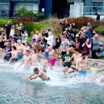 About 100 people dipped three times into the water during the 38th annual Polar Bear Dip on Thursday at Hollywood Beach in downtown Port Angeles. The air and water temperature were both in the low 40s. Each received a certificate for participating, and proceeds benefitted Volunteer Hospice of Clallam County. (Dave Logan/for Peninsula Daily News)