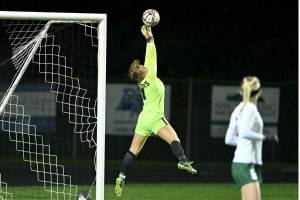 Port Angeles' Kennedy Rognlien makes a leaping save late in the game against Hockinson in the 2A state playoffs, one of 16 saves she made in the game. (Taylor Balkom/The Columbian)