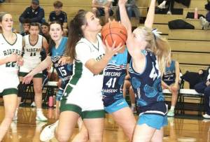 Port Angeles' Sariah Doherty drives the lane against the Surfcoast Chargers, a team from Melbourne, Australia. (Dave Logan/for Peninsula Daily News)