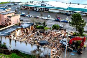 The Sanderling Building, a vacant office building on Water Street across from Quimper Mercantile in downtown Port Townsend, underwent exterior demolition on Monday to clear the lot for a 50-room hotel to be built by BJC Group of Port Orchard. Interior demolition started last week and the site should to be cleared in about a week and a half. (Steve Mullensky/for Peninsula Daily News)