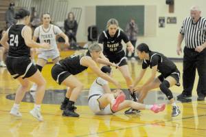 It was a fast moving game between Forks and Raymond-South Bend on Tuesday in Forks. The Spartans defeated RSB 49-42. Here, Forks' Chloe Gaydeski looks for an outlet while surrounded by Ravens from left, Avalyn Stigall, Kassie Koski, Ava Baugher and Megan Kongbouakhay.  Looking on is Forks' Avery Dilley.  (Lonnie Archibald/for Peninsula Daily News)