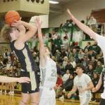 Sequim's Zeke Schmadeke shoots against the defense of Port Angeles's Ashton Gedelman (20) and Abe Brenkman (35). Keilar Point (23) is also on the floor. (Dave Logan/for Peninsula Daily News)