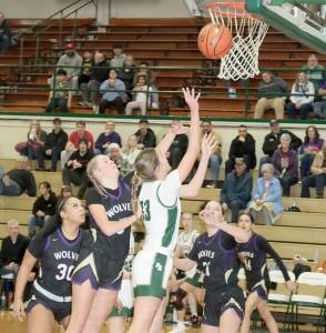 Port Angeles Morgan Politika goes up for a shot against Sequim on Tuesday night in Port Angeles. Defending for Sequim is Indi Mixon (30), Kaiya Robinson (5) and Hailey Wagner (21). (Dave Logan/for Peninsula Daily News)