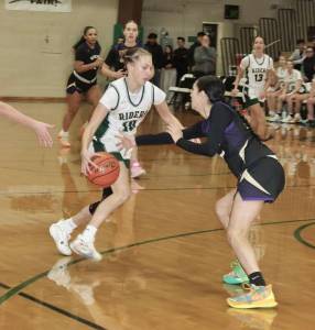 Dave Logan/for Peninsula Daily News
 Port Angeles Teanna Clark, pictured driving against Sequims Gracie Chartraw in a game Tuesday night, scored nine points in the fourth quarter of the Roughriders win over Bainbridge on Wednesday.