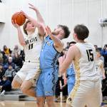 Peninsula Colleges Gus Halberg (Port Angeles High School) goes up for a shot against Whatcom on Saturday. Halberg had a crucial 3-point shot in the final minutes of the game.